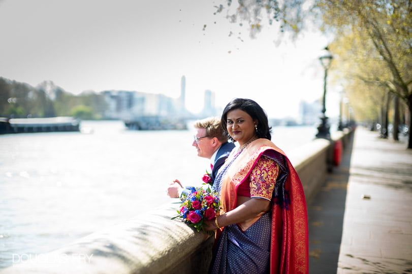 Bride and groom photographed together on the Embankment in London