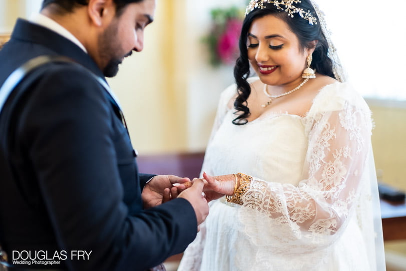 Photograph of couple exchanging rings in Chelsea Register Office