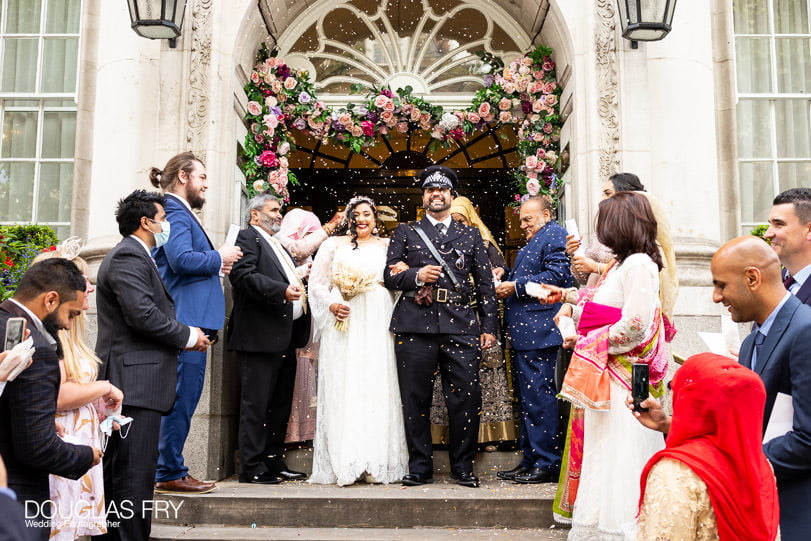 Wedding photographer picture of couple on steps of chelsea town hall kings road London