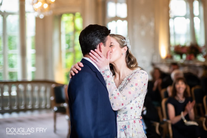 Wedding photograph of bride and groom kissing in London