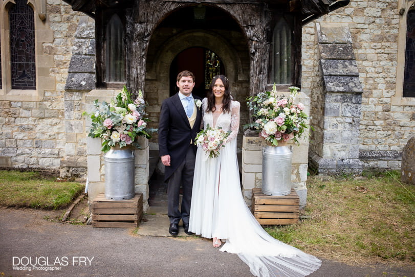 Surrey wedding photographer - couple in front of church