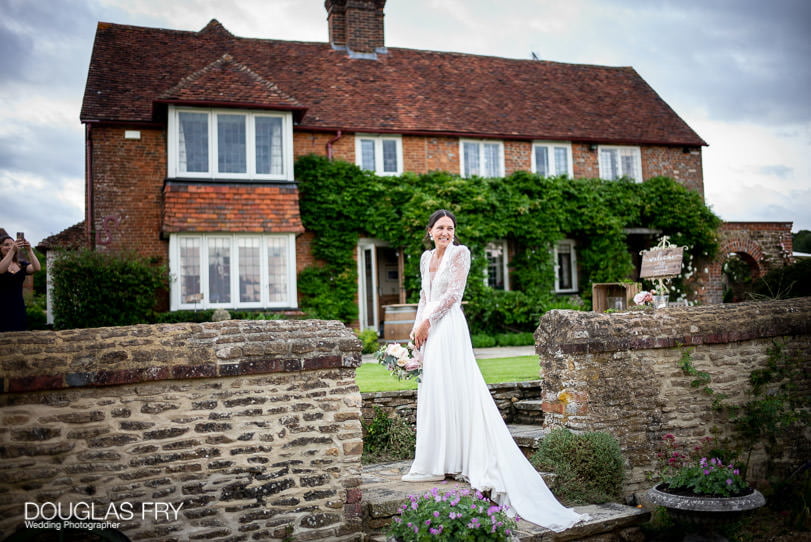 bride throwing bouquet at Surrey home