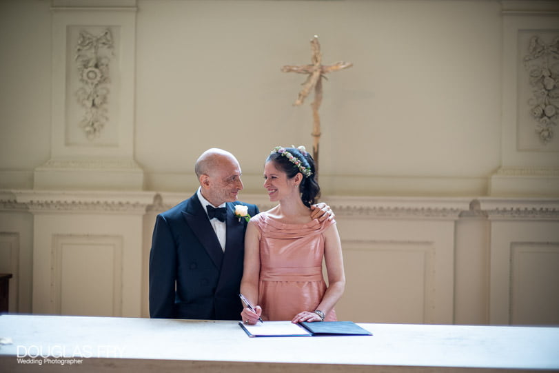 Wedding Photographer at The Athenaeum Club in London 5 Signing the register at St Martin's in the Fields, London