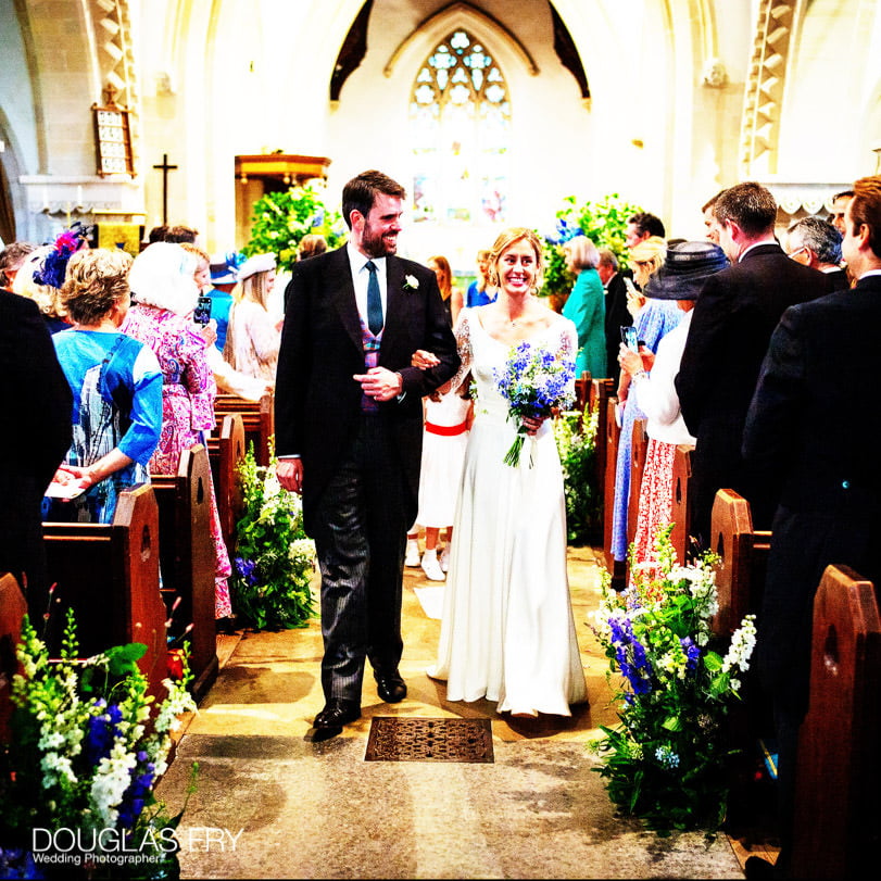Bride and groom in church at end of wedding service