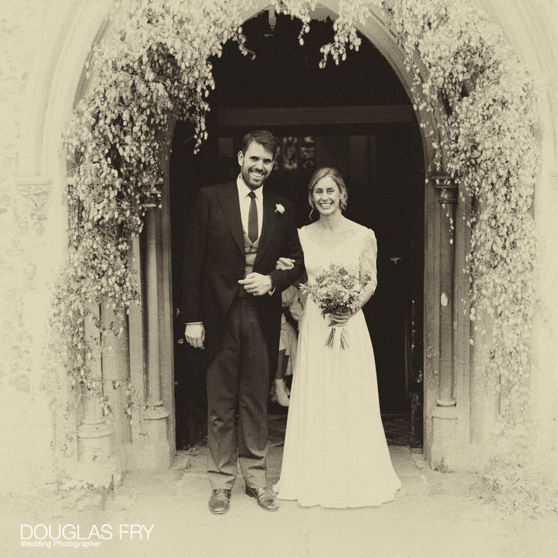 Bride and groom at church door in Wiltshire