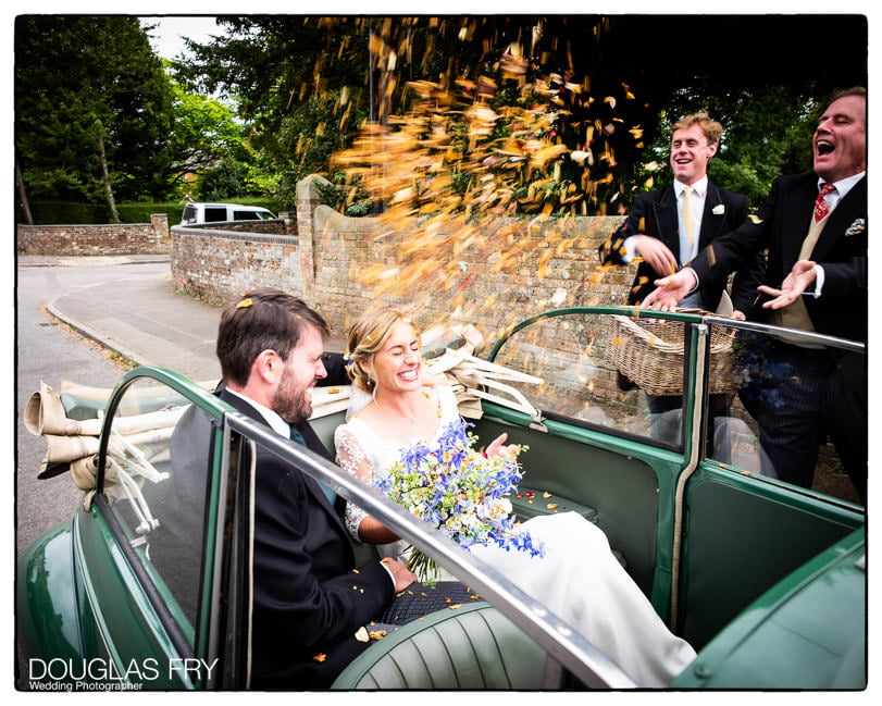 Confetti and classic car photographed at Marlborough wedding