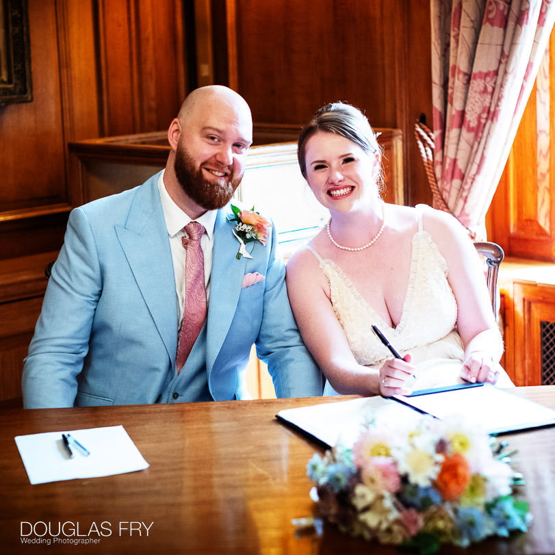 bride and groom signing the regiser at their wedding at Inner Temple in London