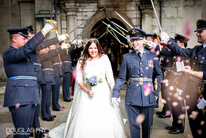 Military Wedding Photographer at St Clements Dane Church and The RAF Club in London 5 St Clement Danes Church - leaving through arch of swords - RAF