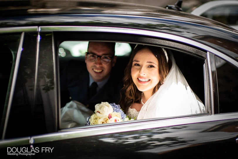 Military Wedding Photographer at St Clements Dane Church and The RAF Club in London 6 bride and groom leaving by car on wedding day after service