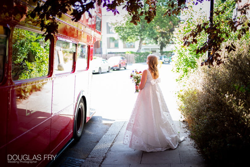 photograph of Bride standing by London bus 