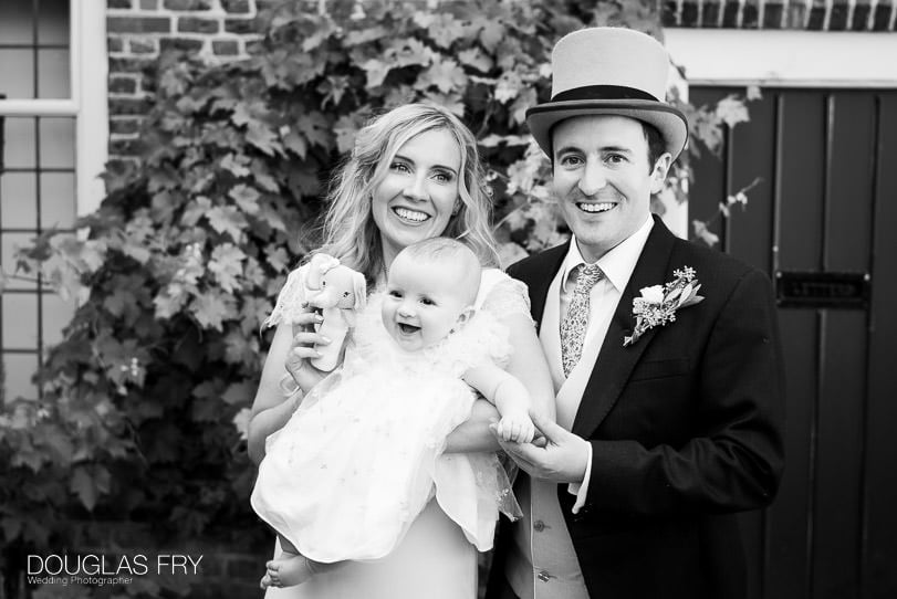 couple and baby at wedding reception