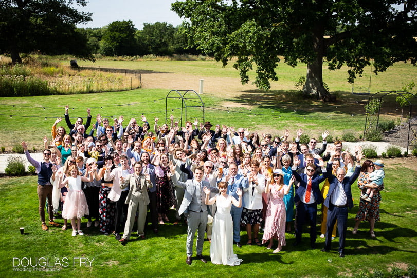 wedding reception photograph - all the guests together waving