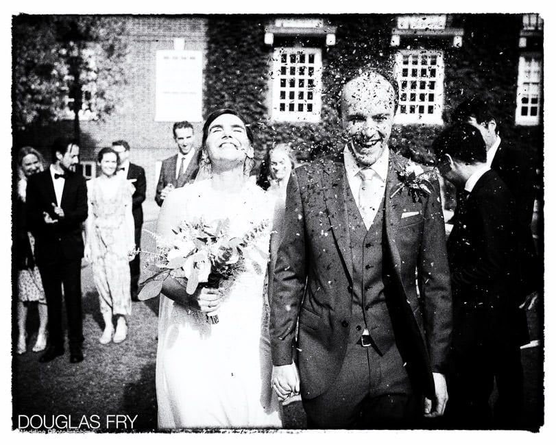 Bride and groom photographed at Gray's Inn in London - black and white with confetti