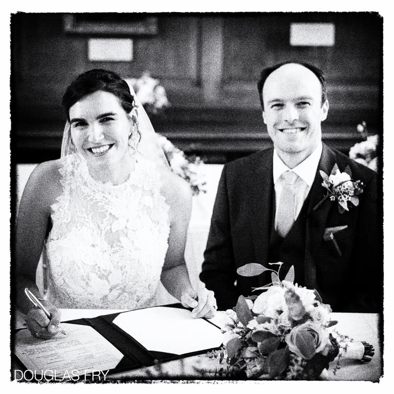 Bride and groom photographed at Gray's Inn in London - signing the register
