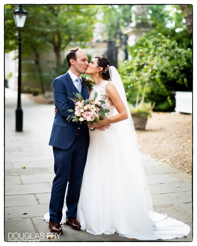 Bride and groom photographed at Gray's Inn in London - a kiss