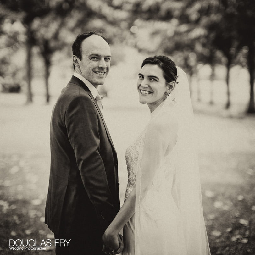 Bride and groom photographed at Gray's Inn in London - walking in the grounds