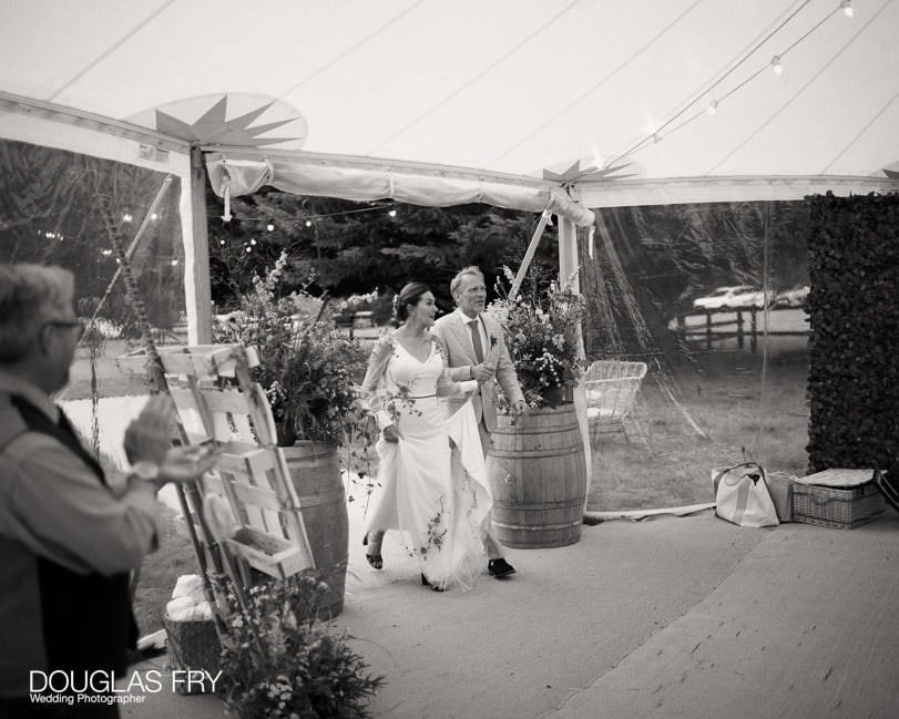 Wedding photography - Hampshire photographer -bride and groom entering marquee