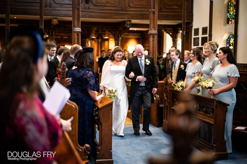 Wedding photographer - bride with father in Dulwich church - London