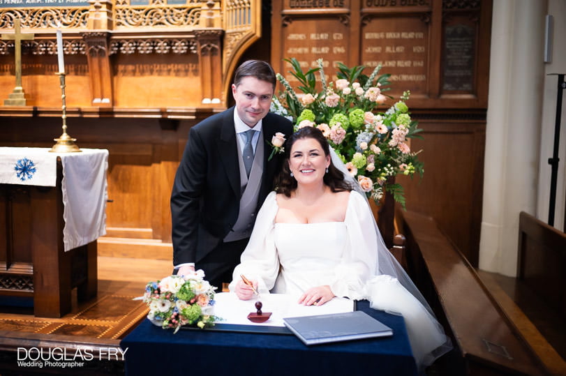 Wedding photographer - signing register in Dulwich church