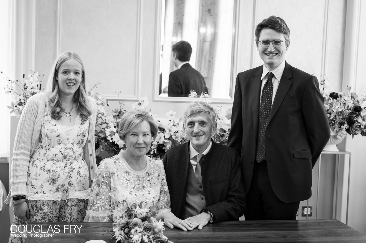 Chelsea Register Office photography by Douglas Fry of couple and guests during signing of register.