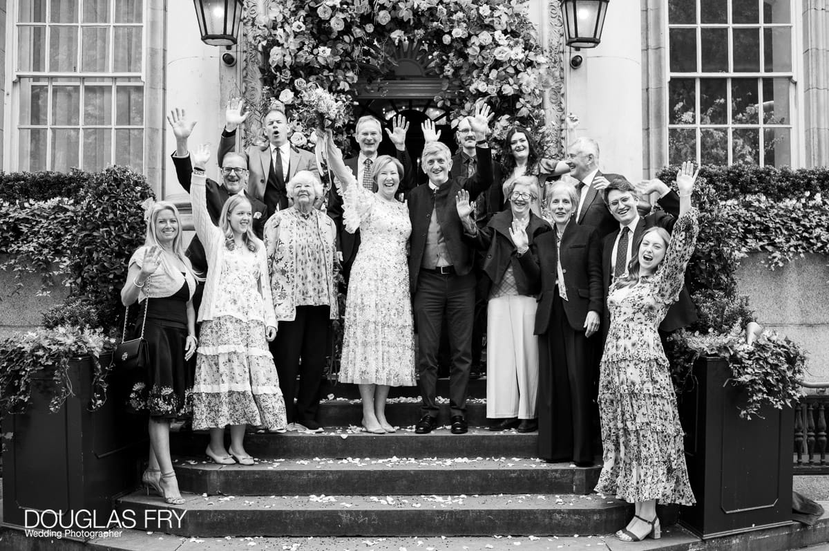 Chelsea Register Office photography by Douglas Fry of couple and guests on steps out onto King's Road in London