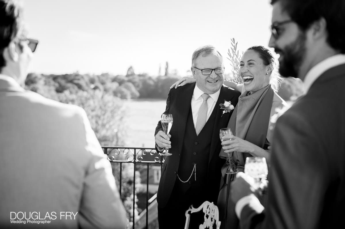 Guests toasting the couple - wedding photography by Douglas Fry at the Petersham Hotel