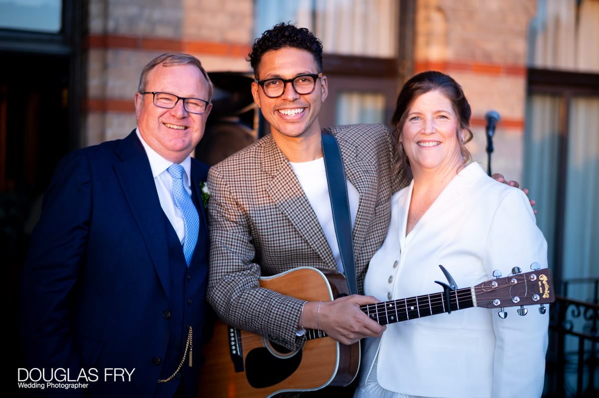 The happy couple photographed by wedding photographer in front of the Petersham Hotel in Richmond