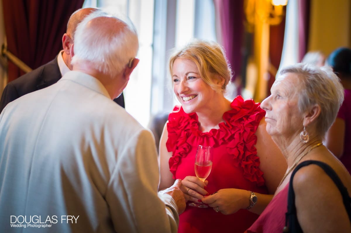 Guests photographed by wedding photographer during reception at Trinity House in London