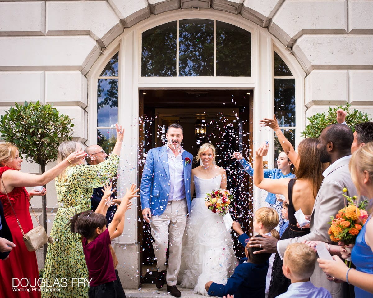 Bride and groom with confetti at Trinity House photographed by wedding photographer in London