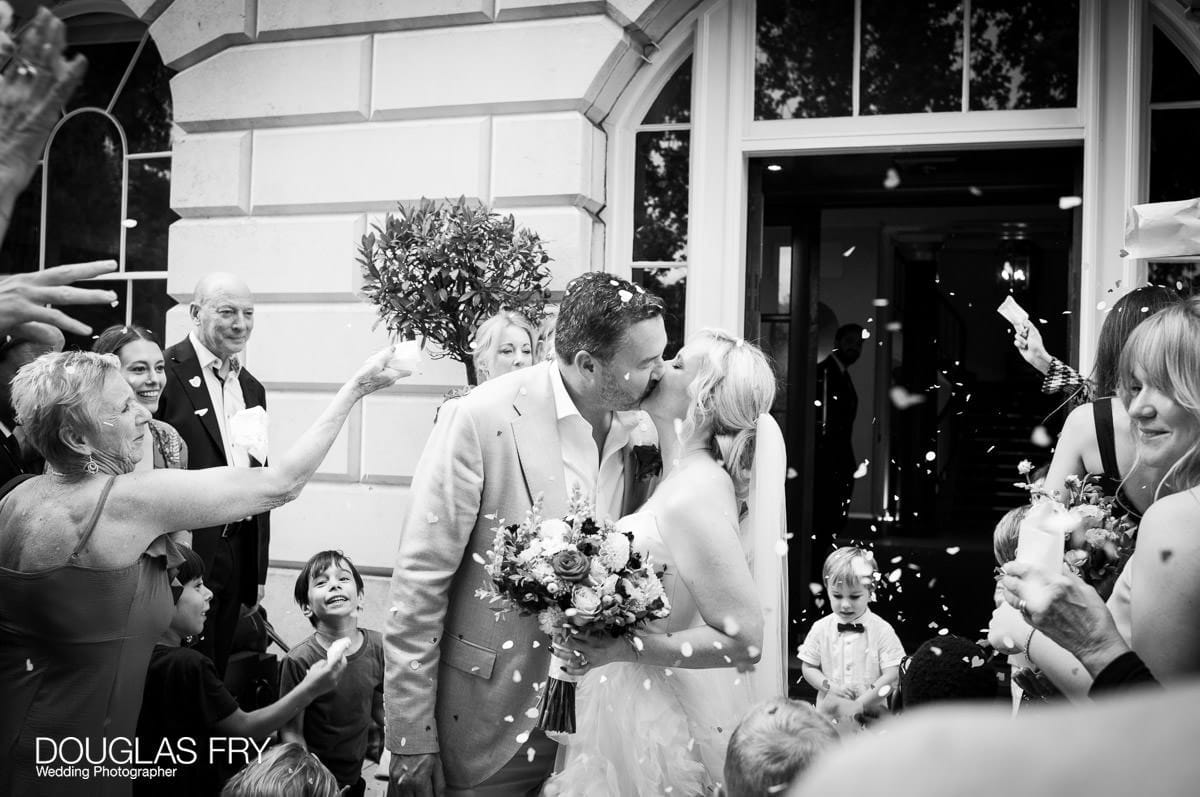 Bride and groom photographed kissing by wedding photographer